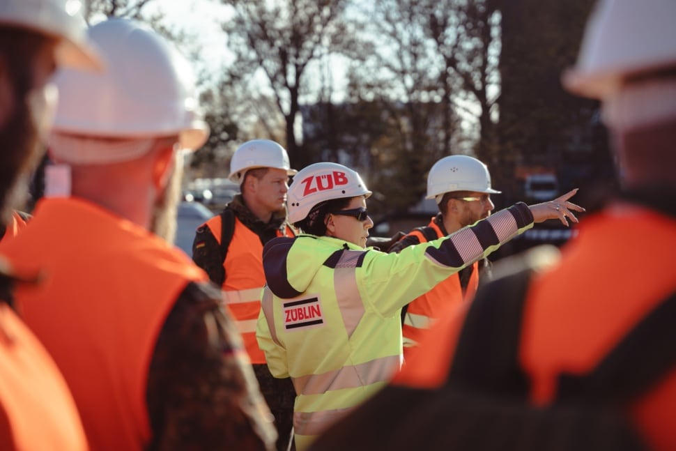 Eine Bauleiterin erklärt Soldaten den Umgang im Bauwesen